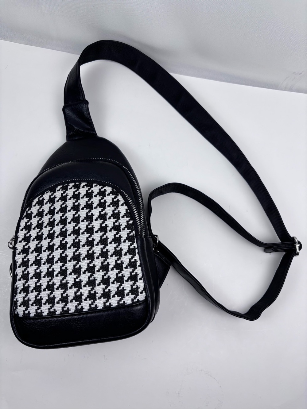 INICAT Houndstooth Sling Bag. sleek black faux-leather body
